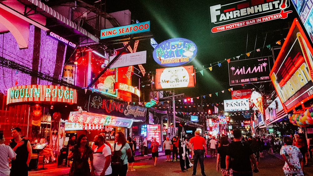 people standing between store buildings at nighttime