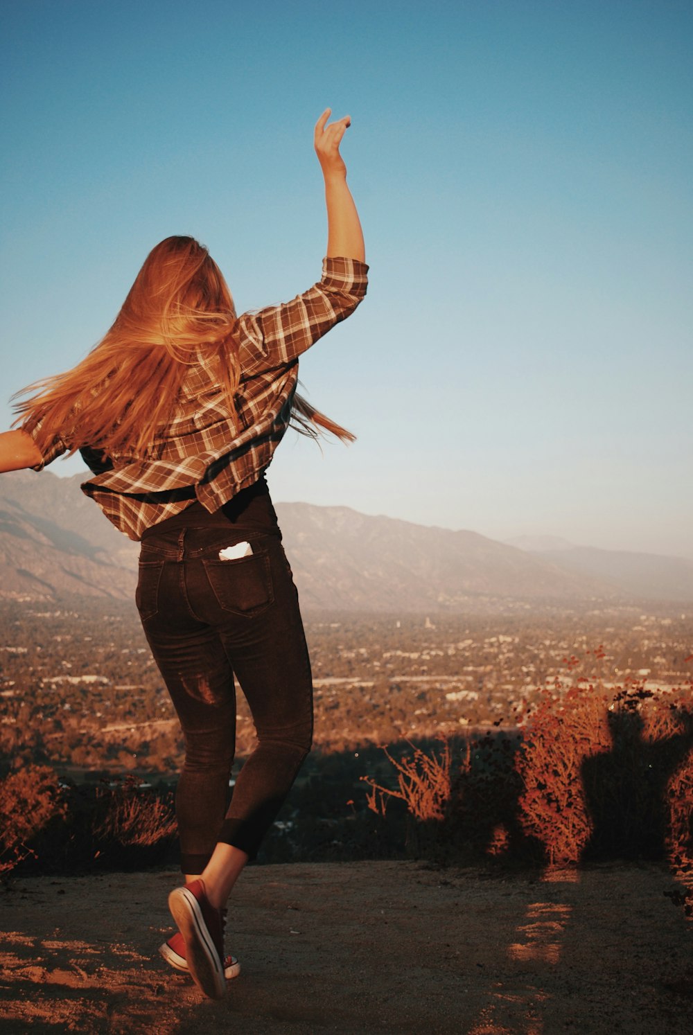 woman standing on cliff