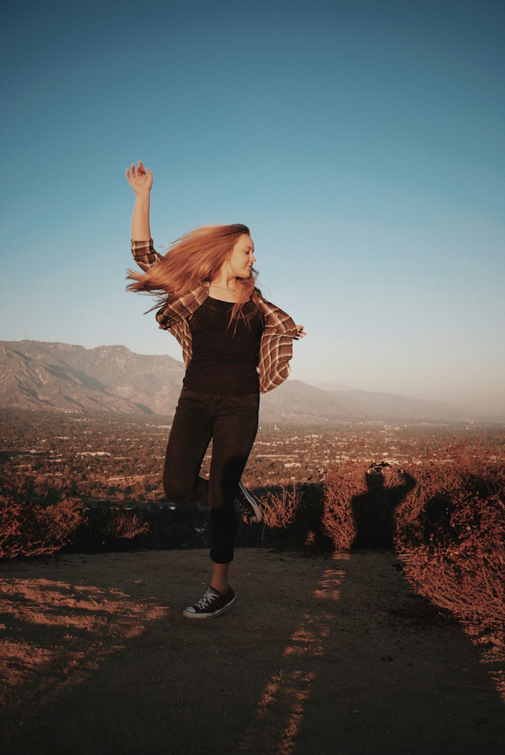 woman standing under blue sky