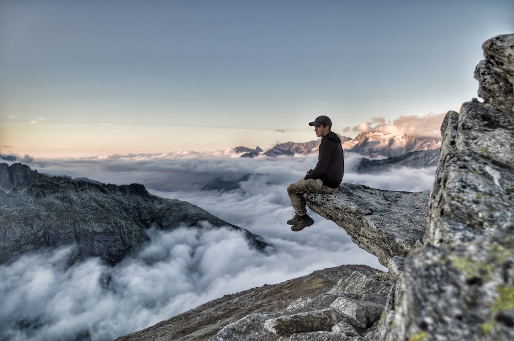 man sitting on rock formation