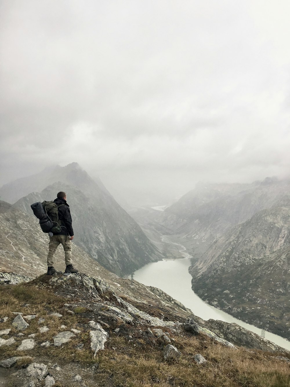 man standing on rock boulder