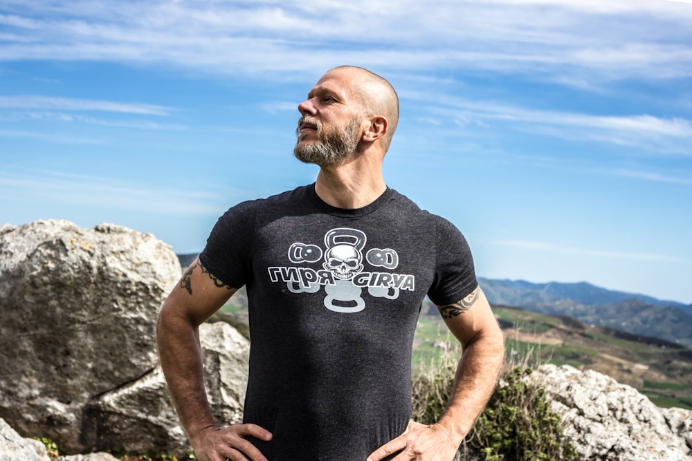 man standing near rock formation