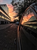 A vibrant sunset reflecting on a car's shiny surface.