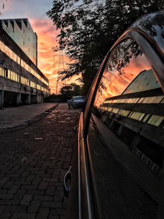 A vibrant sunset reflecting on a car's shiny surface.
