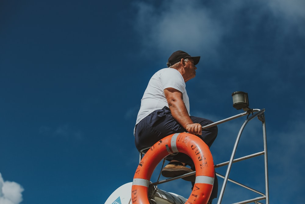 man sitting on metal bar