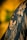 A black and white tattoo is depicted on skin, featuring a detailed face with long, flowing hair. Above the face, a skull is intricately integrated into the design, creating a mysterious and artistic composition. The background is a blurred gradient of yellow and green, enhancing the contrast of the tattoo art.