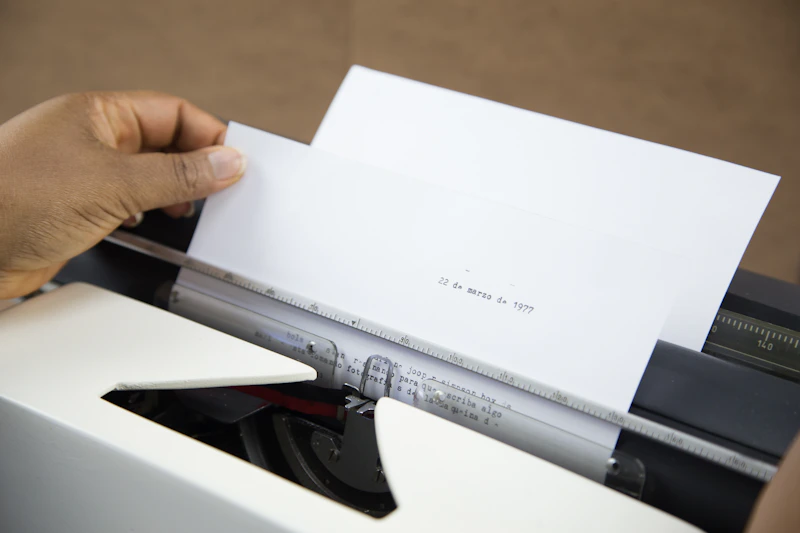 Hand placing a document into a printer