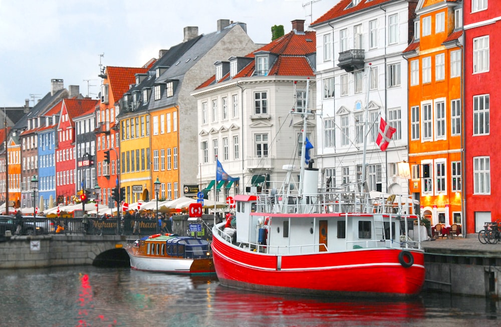 red boat parked near buildings