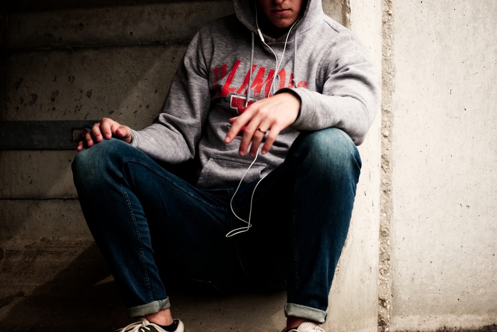 man sitting on concrete