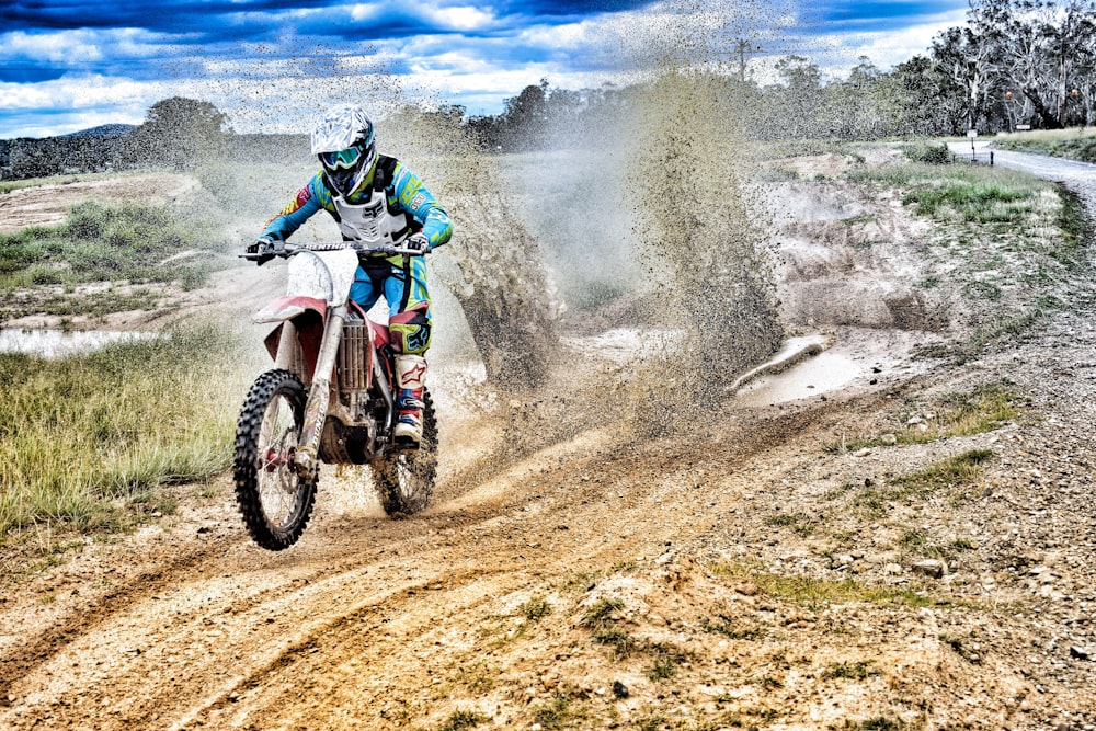 man riding on red and white motocross dirt bike