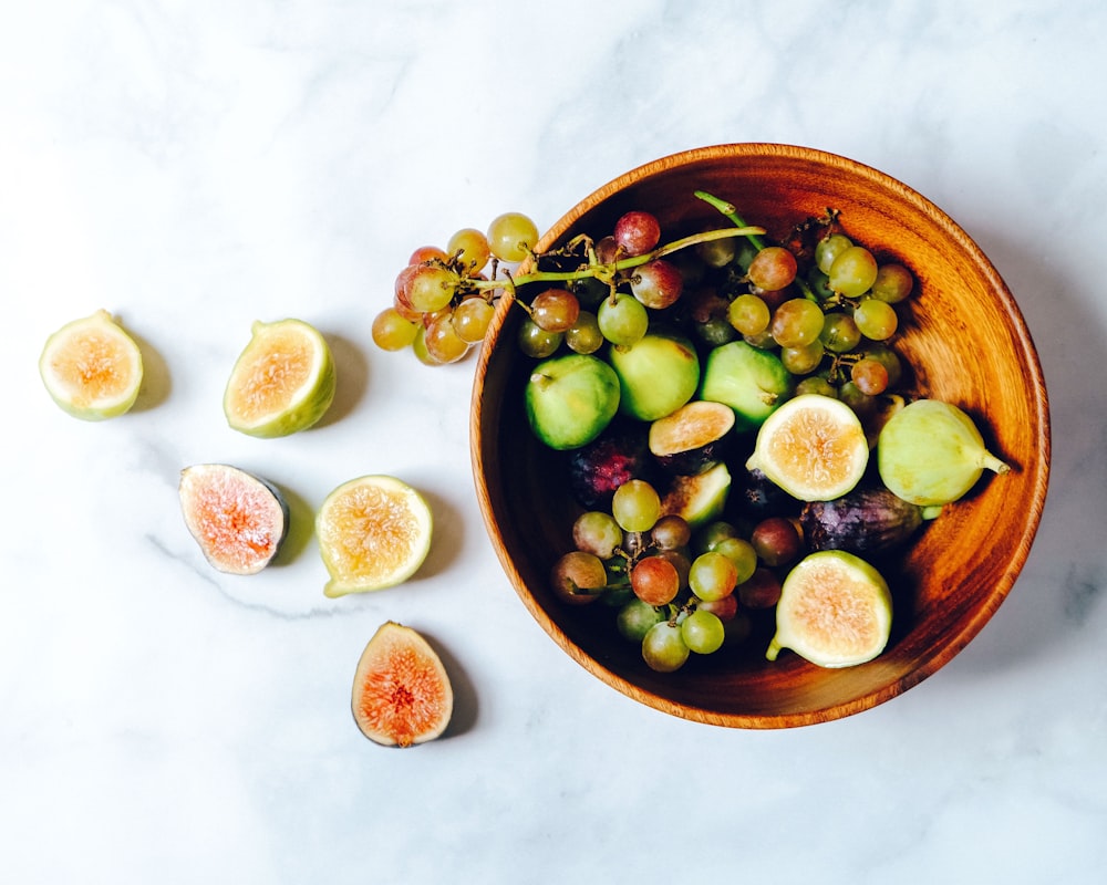 food photography of sliced fruits on brown bowl