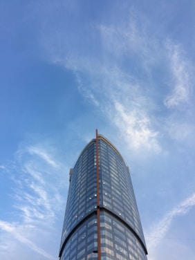 A modern, sturdy building standing resiliently against a clear blue sky.