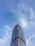 A modern steel building standing tall under a clear blue sky against a vibrant landscape.