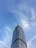 A modern steel building standing tall under a clear blue sky against a vibrant landscape.