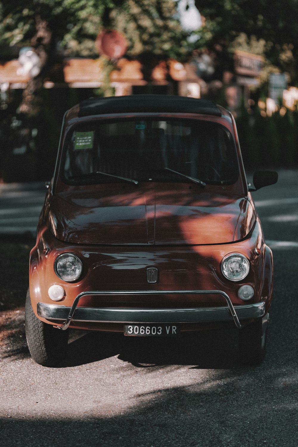 brown classic car on park