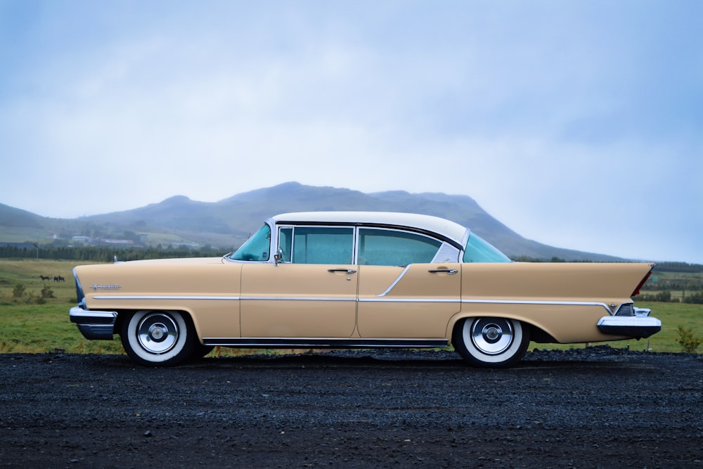 vintage beige sedan on the road