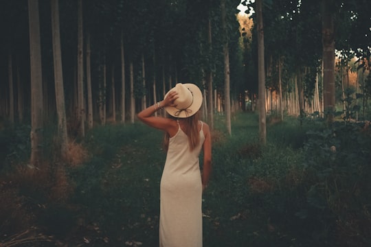 woman in white spaghetti strap dress near trees in Cijuela Spain