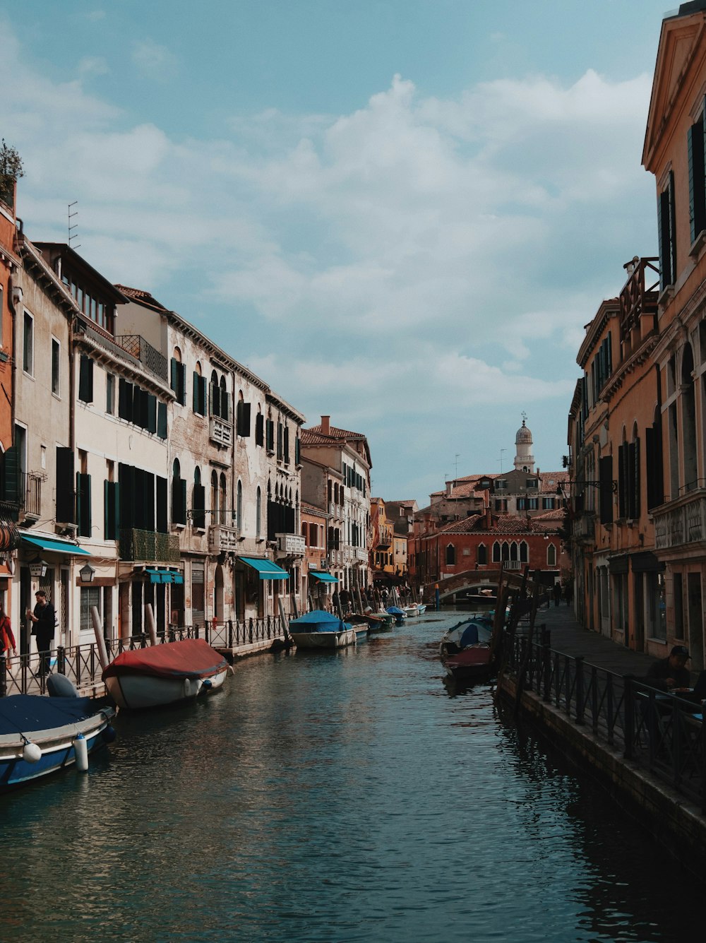 white concrete houses near boats during daytime