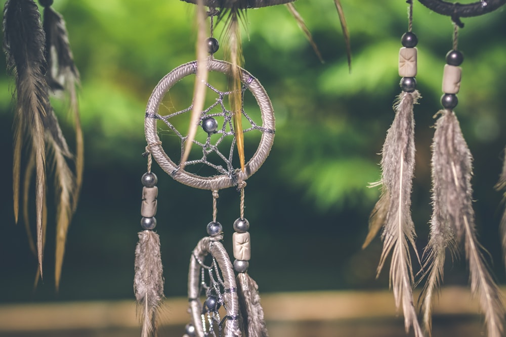 close-up photo of gray dreamcatcher pendants