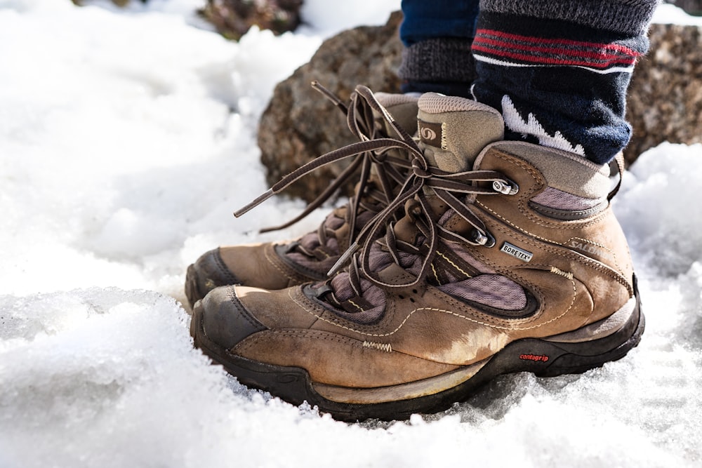 person wearing brown hiking shoes