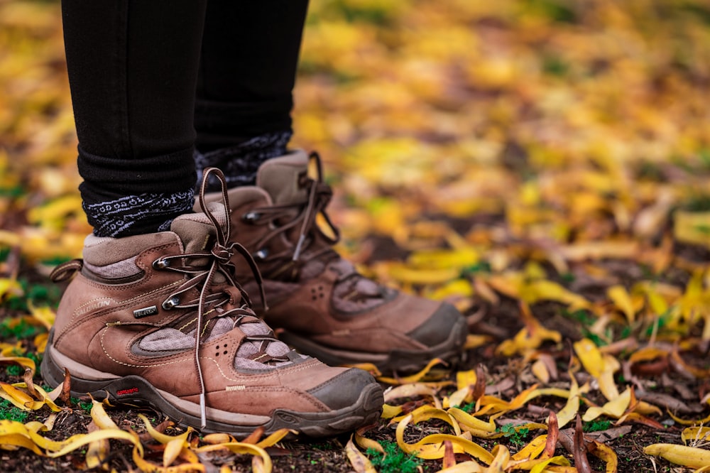 person wearing brown hiking boots