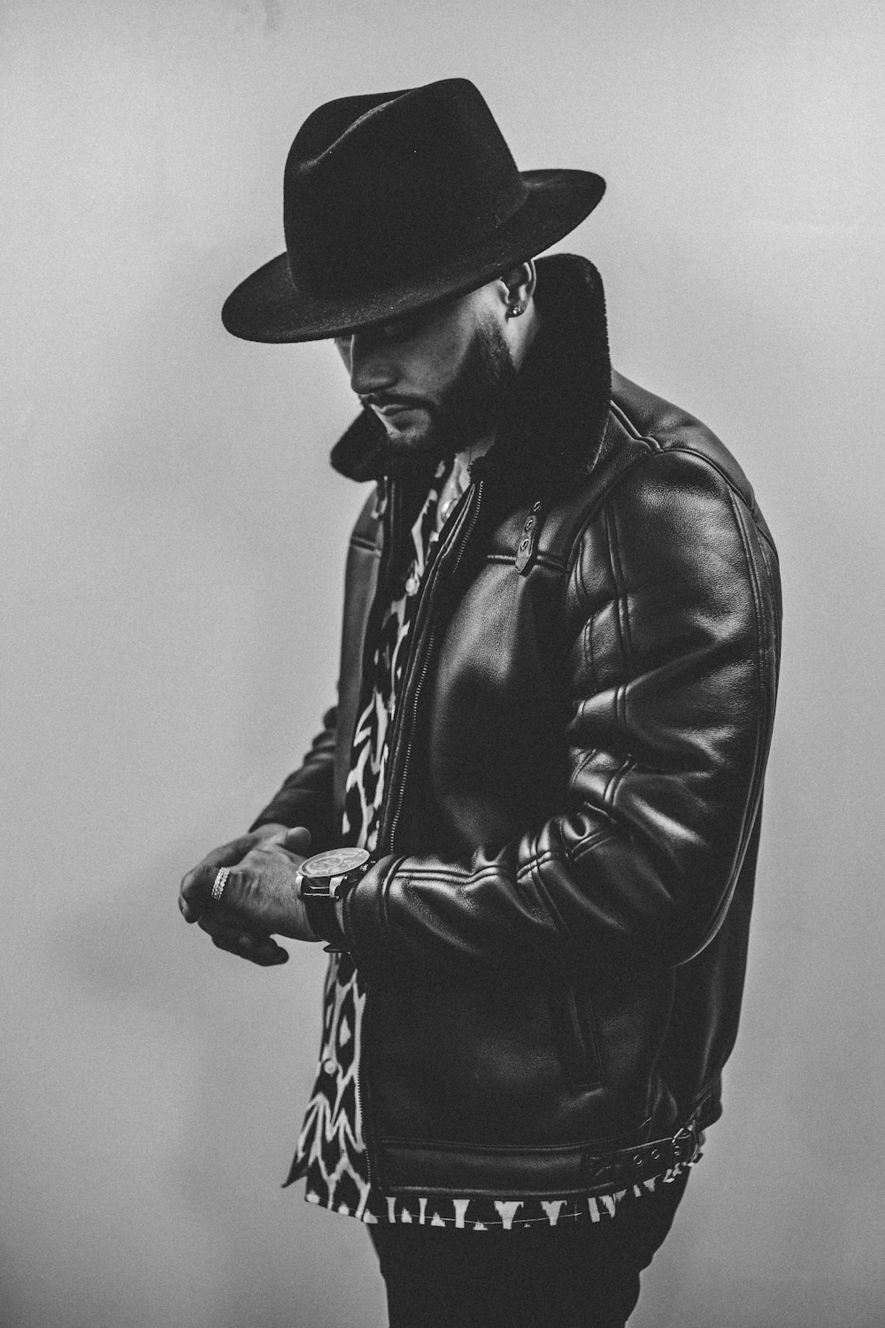 grayscale photography of man wearing black leather jacket