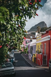 man beside red painted house