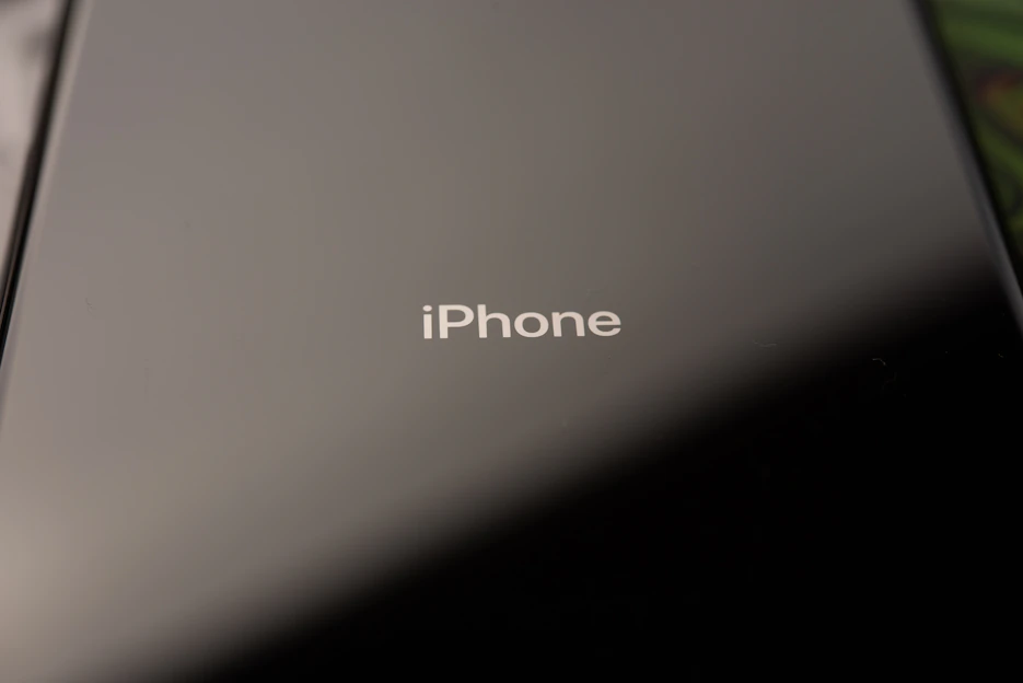 Close-up of a sleek iPhone with a crystal-clear screen protector being applied.