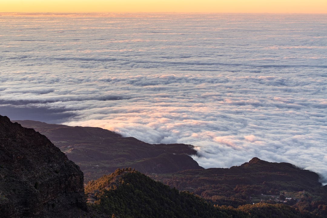 aerial photography of clouds covered mountains