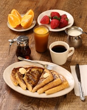 food photography of strawberries, oranges, and pancakes on plates