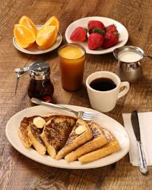 food photography of strawberries, oranges, and pancakes on plates