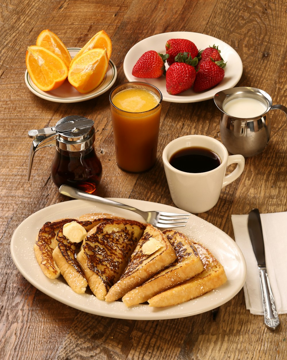 food photography of strawberries, oranges, and pancakes on plates