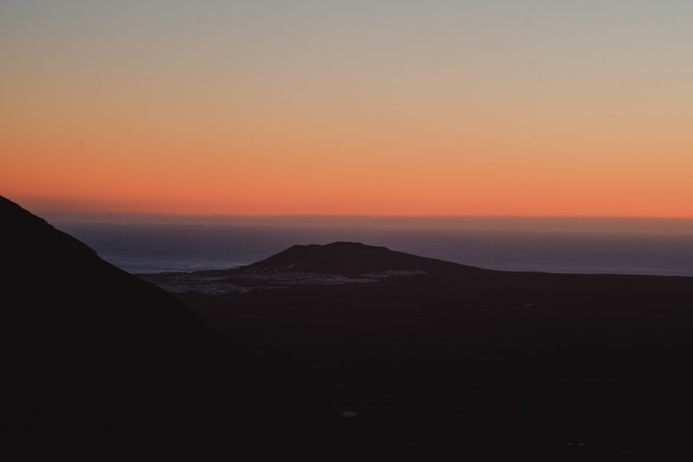 silhouette of mountain range during sunset