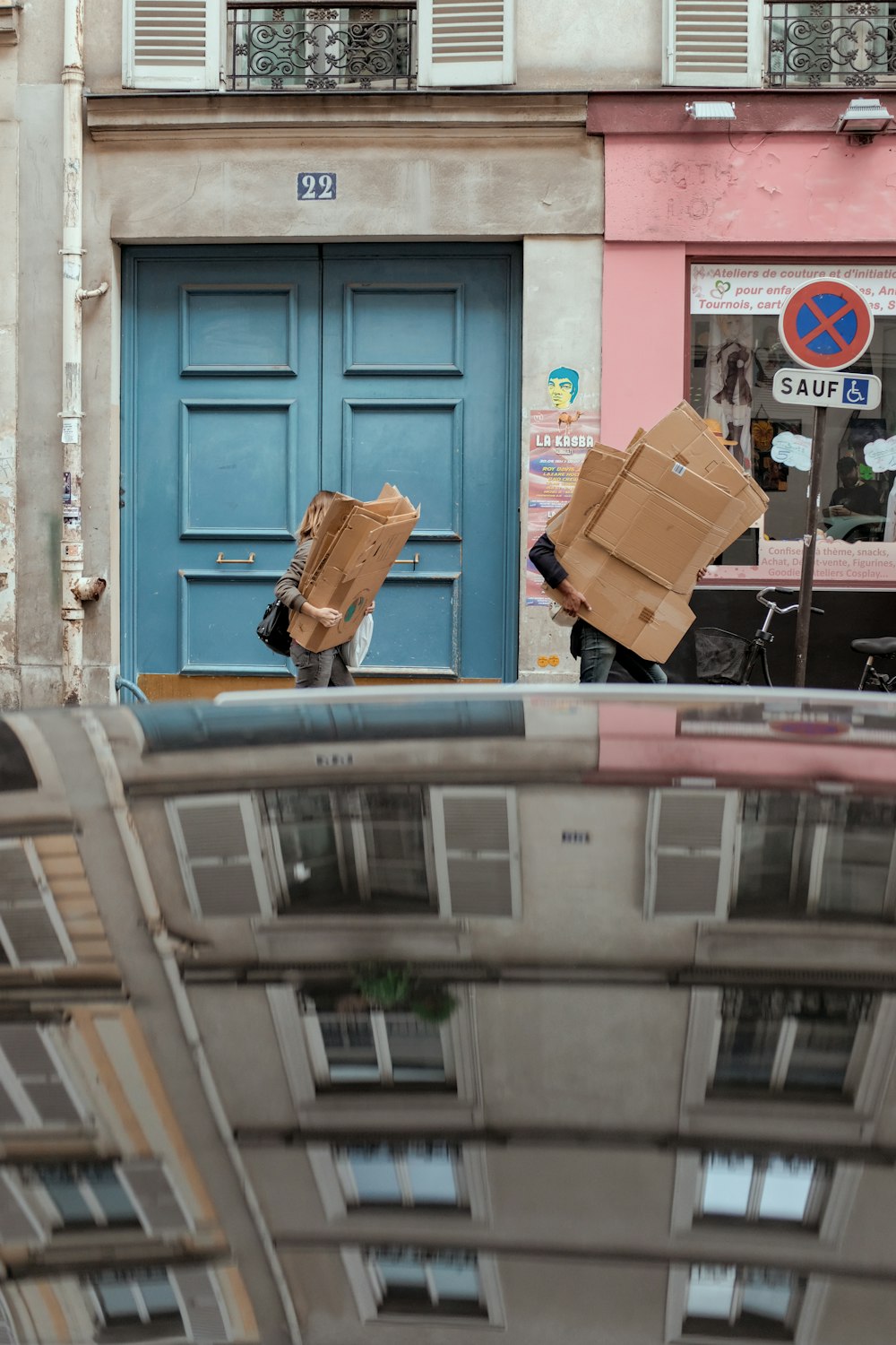 woman carrying cardboard boxes