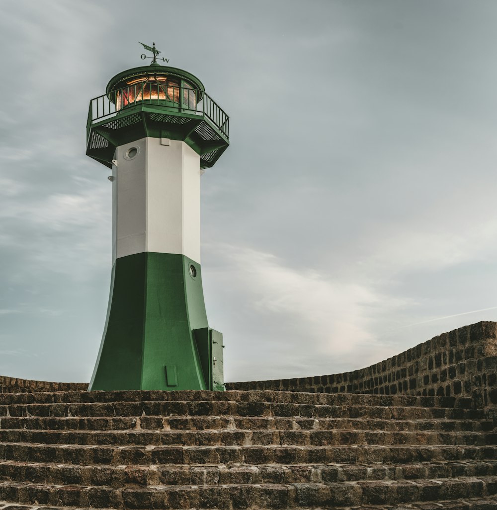 photography of green and white lighthouse