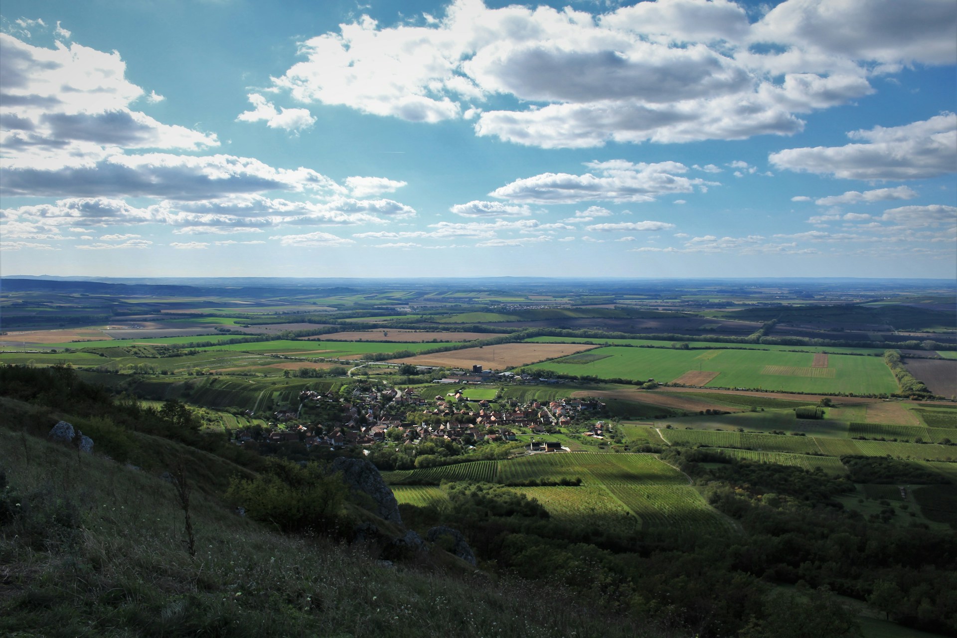 woman wearing yellow long-sleeved dress under white clouds and blue sky during daytime