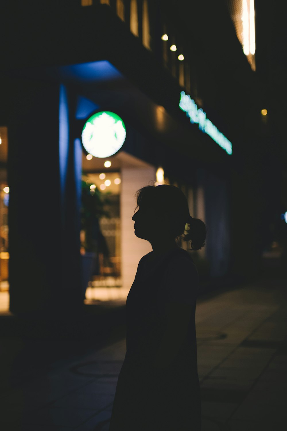 silhouette of woman standing on street