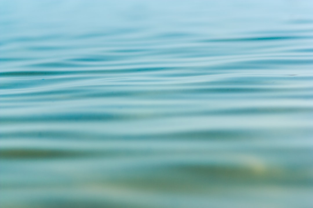 a blurry photo of a body of water, Calm at the Dead Sea