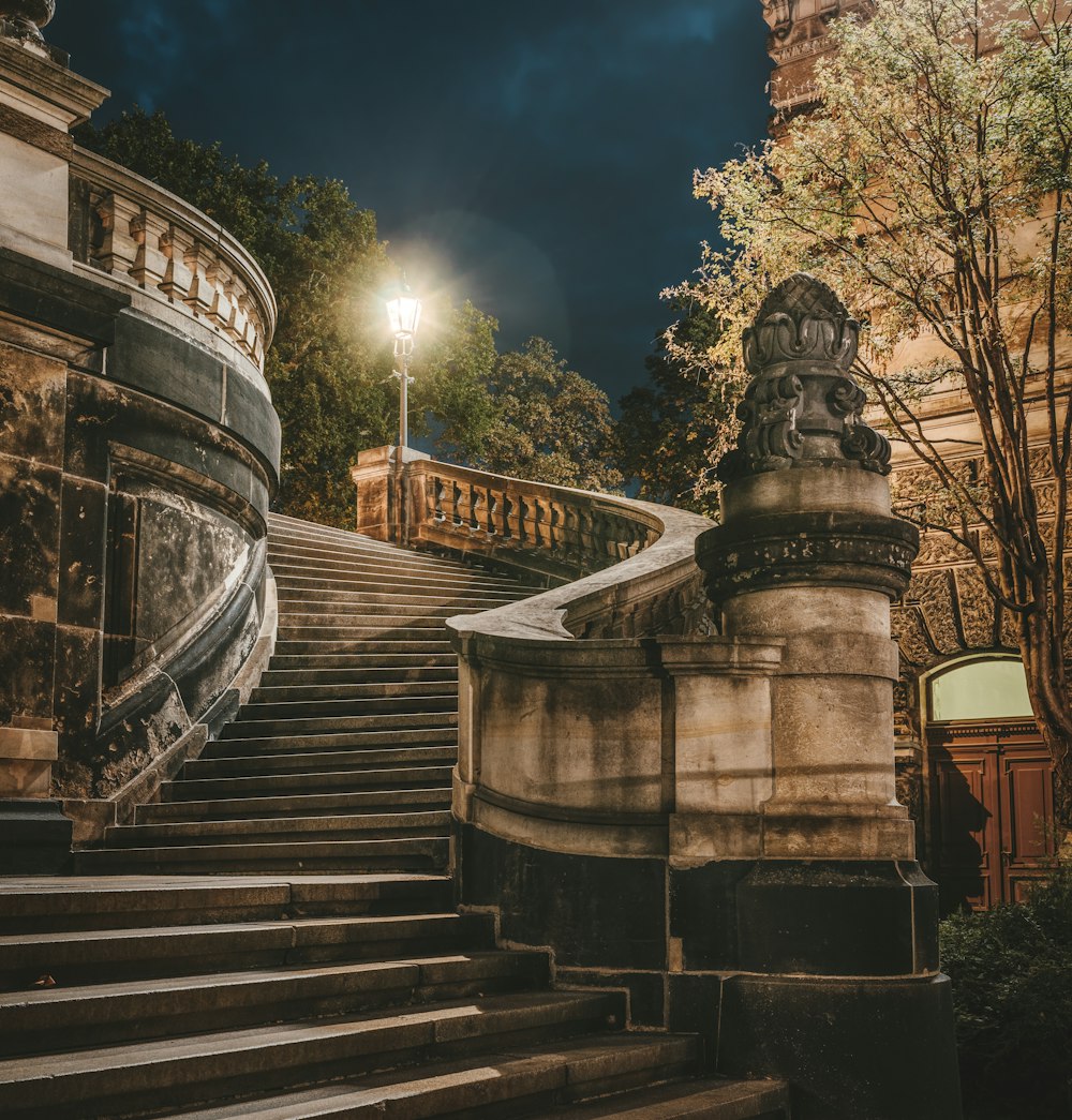 black and brown manor staircase under dark sky