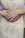 Close-up of a couple holding hands, showing their unique wedding bands.