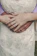 Close-up of a couple holding hands, showing elegant wedding rings.