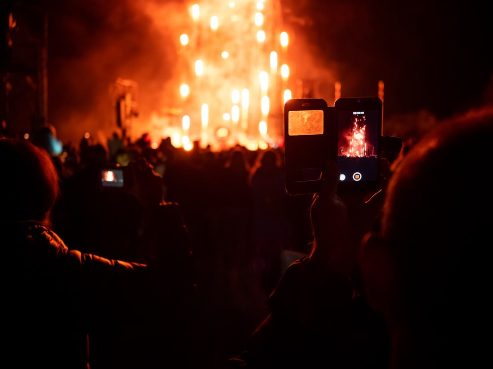 person taking picture of fireworks