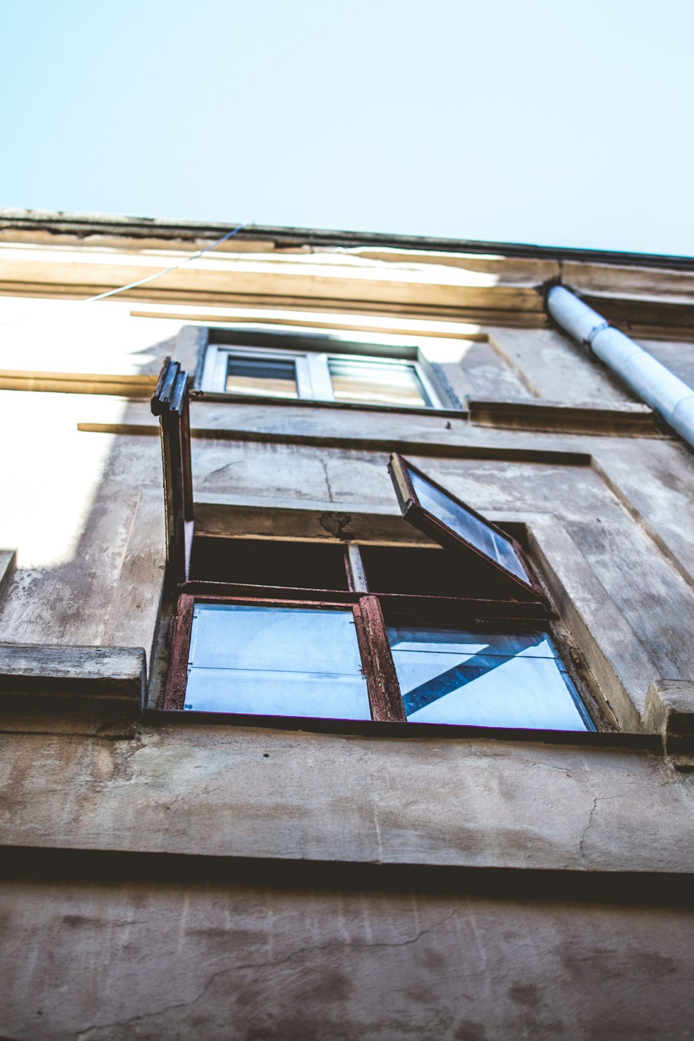 clear glass window and brown frame during daytime