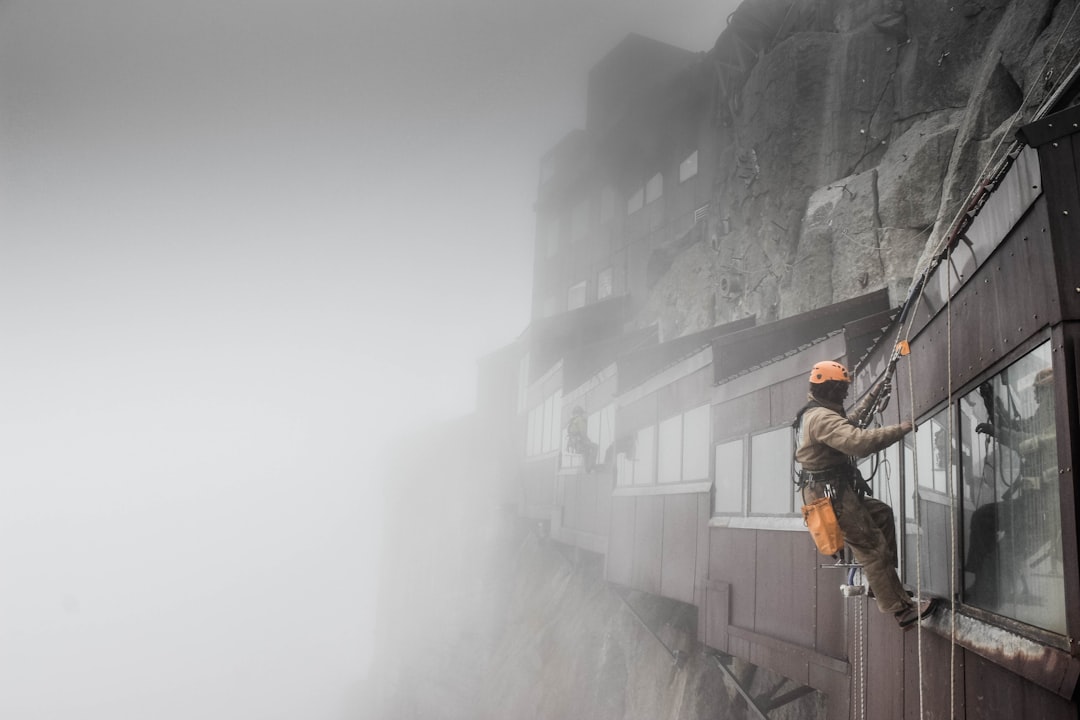 man climbing near houses