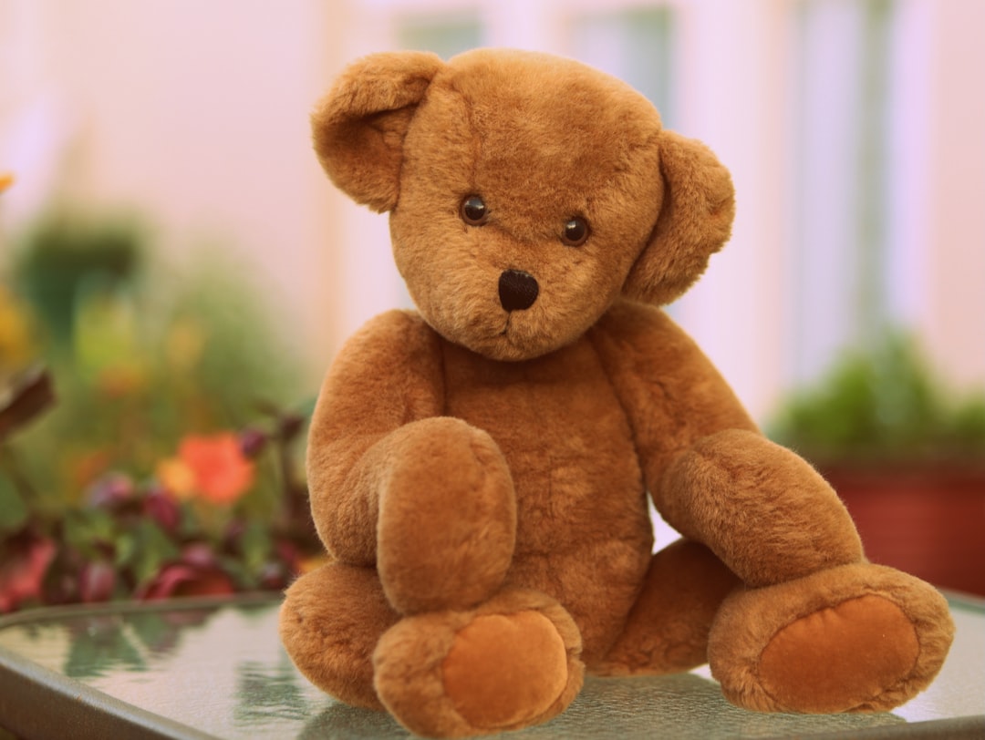 Adorable, stuffed teddy bear, sitting on a counter