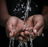 pouring water on person's hands