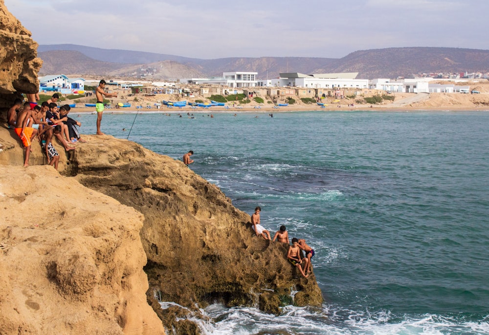 group of people climbing on cliff