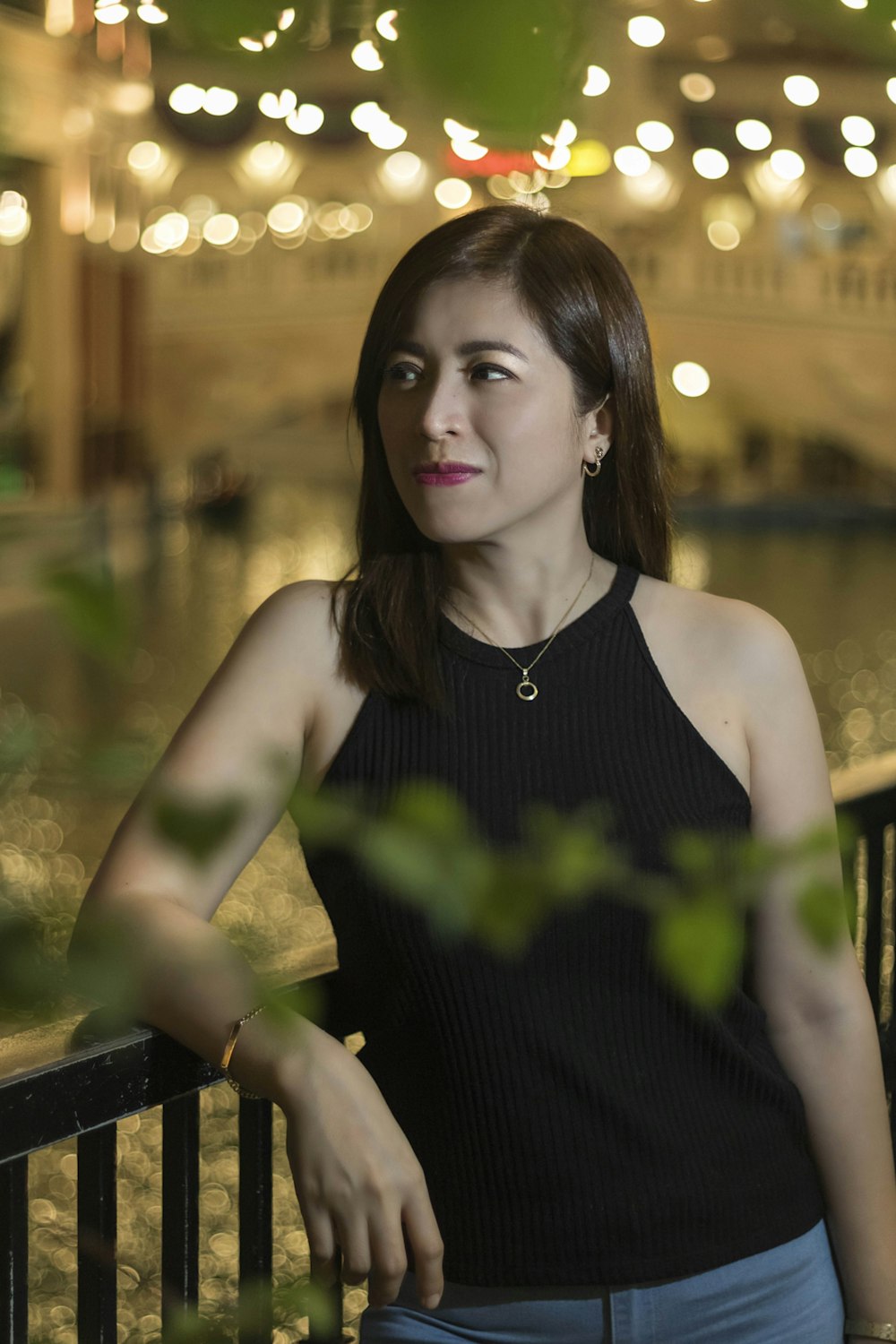 shallow focus photo of woman in black sleeveless shirt