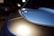 A close-up of a shiny car hood reflecting sunlight, showcasing a professional detailing job.