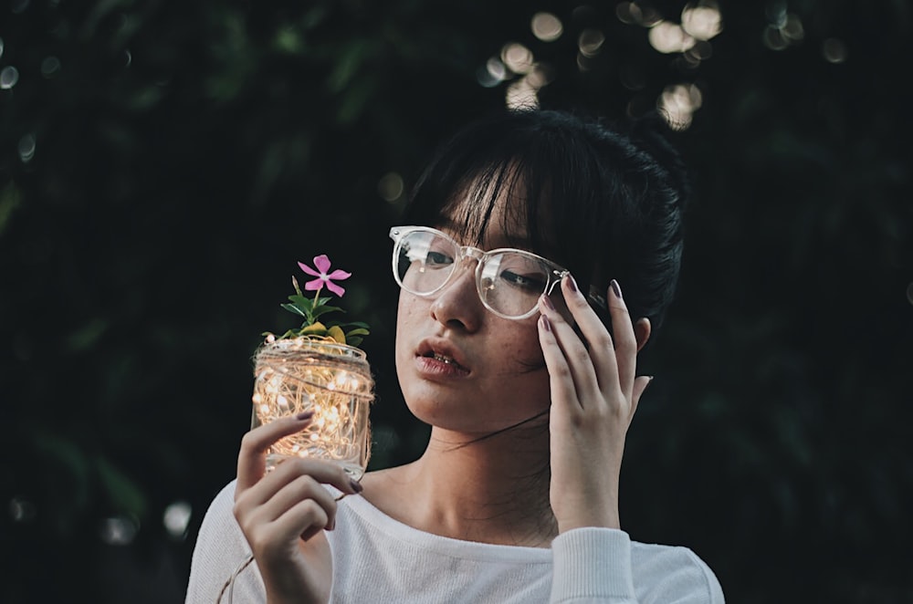 woman holding decorative jar